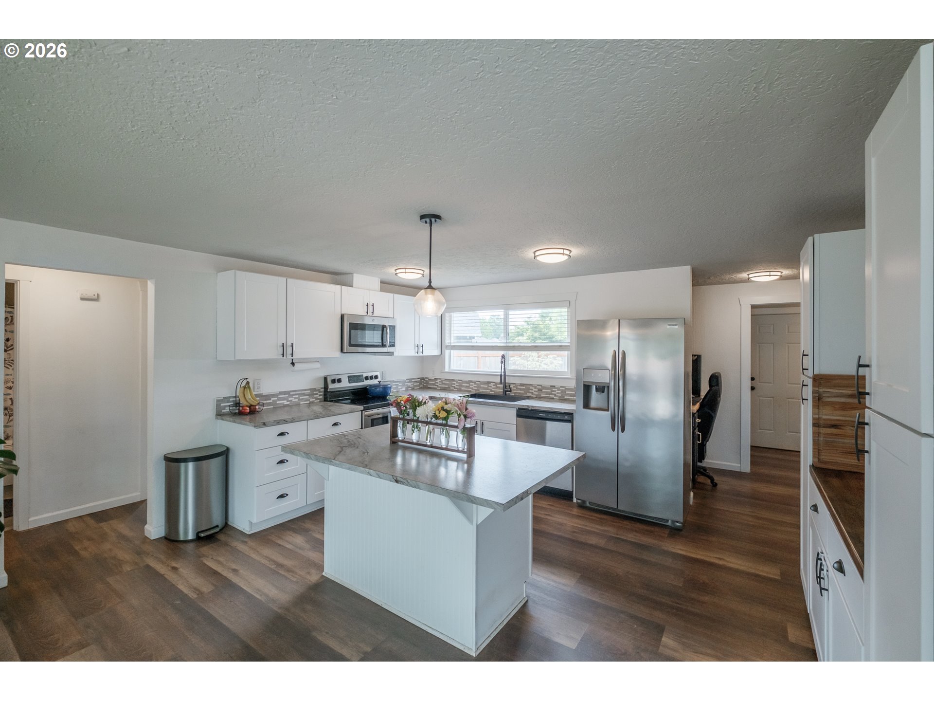 2261 Fulton Place Southeast Albany, OR 97322 - Photo 13 of 48 a kitchen with stainless steel appliances granite countertop a refrigerator a sink a stove and white cabinets with wooden floor