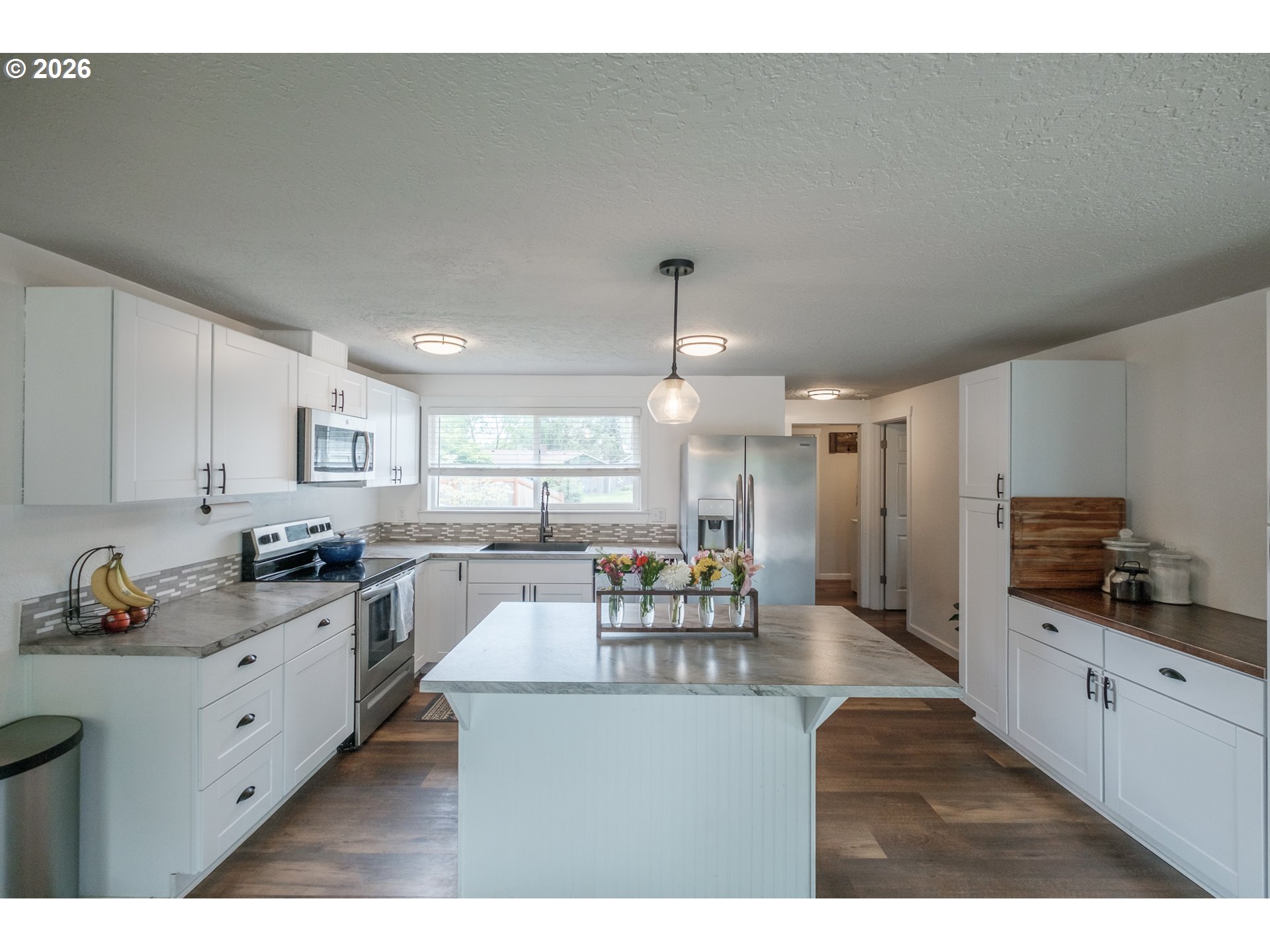 2261 Fulton Place Southeast Albany, OR 97322 - Photo 14 of 48 a open kitchen with granite countertop a stove a sink a dining table and chairs