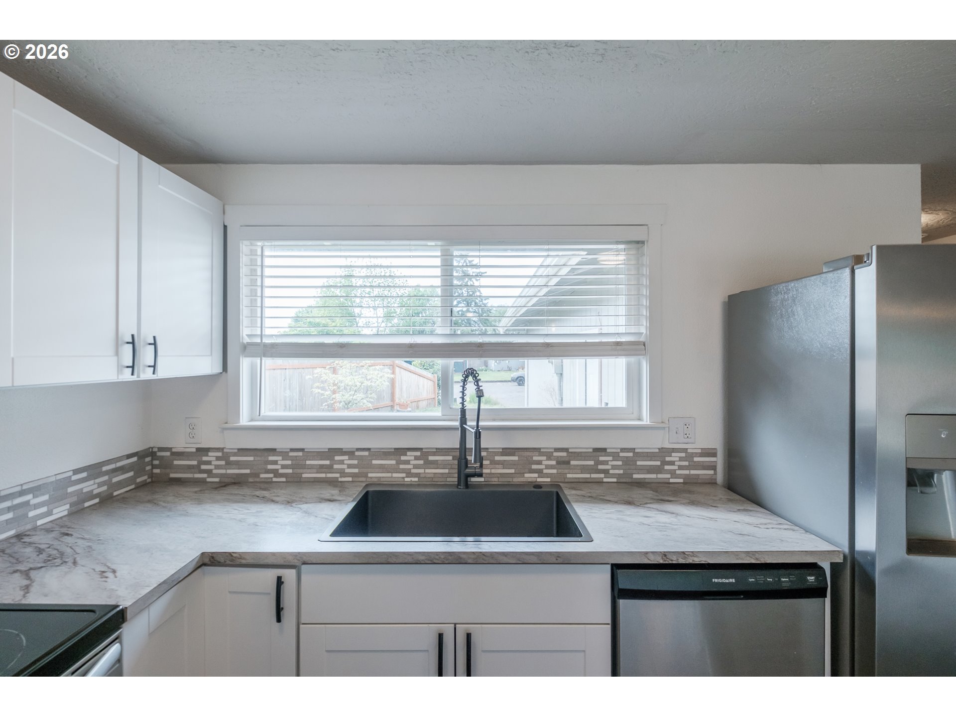 2261 Fulton Place Southeast Albany, OR 97322 - Photo 18 of 48 a kitchen with a sink a window and refrigerator