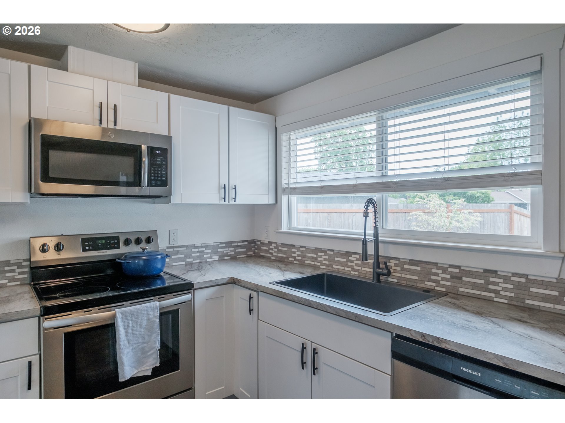 2261 Fulton Place Southeast Albany, OR 97322 - Photo 21 of 48 a kitchen with stainless steel appliances a stove sink microwave and cabinets