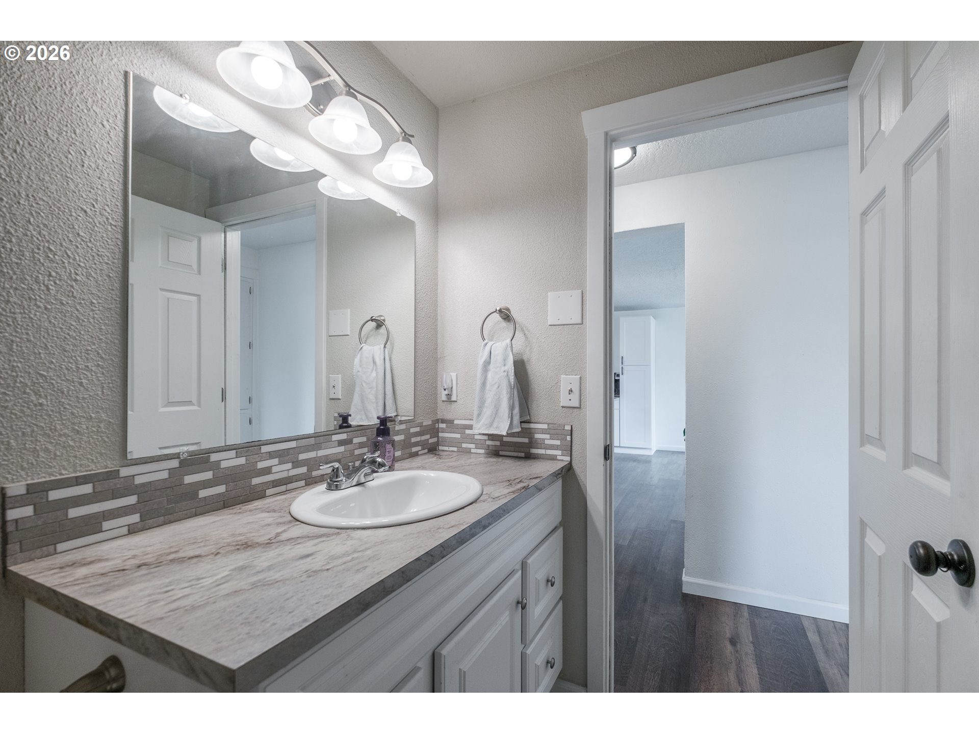 2261 Fulton Place Southeast Albany, OR 97322 - Photo 32 of 48 a bathroom with a granite countertop sink a mirror and a vanity