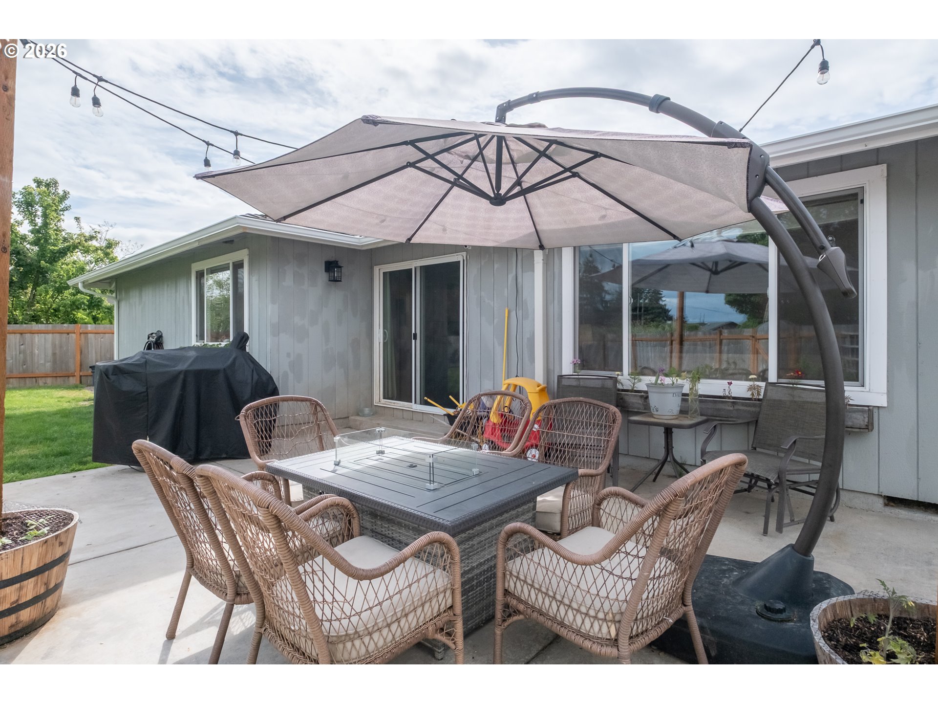 2261 Fulton Place Southeast Albany, OR 97322 - Photo 35 of 48 a view of a patio with table and chairs under an umbrella