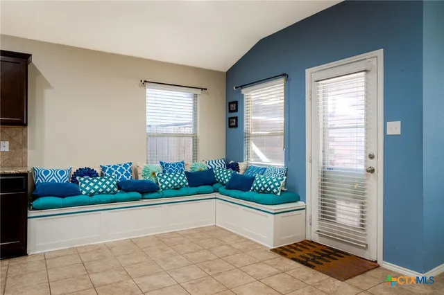 a large kitchen with a large counter top stainless steel appliances and cabinets