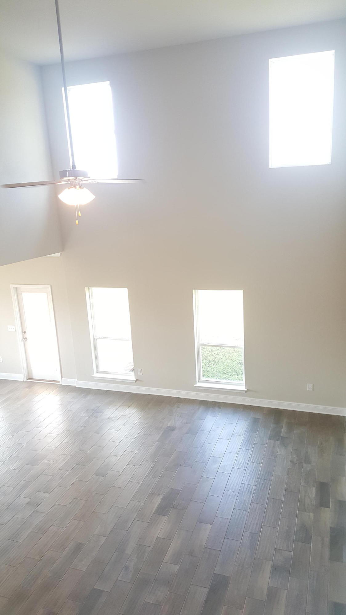246 Conner Circle Santa Rosa Beach, FL 32459 - Photo 10 of 31 an empty room with wooden floor and windows