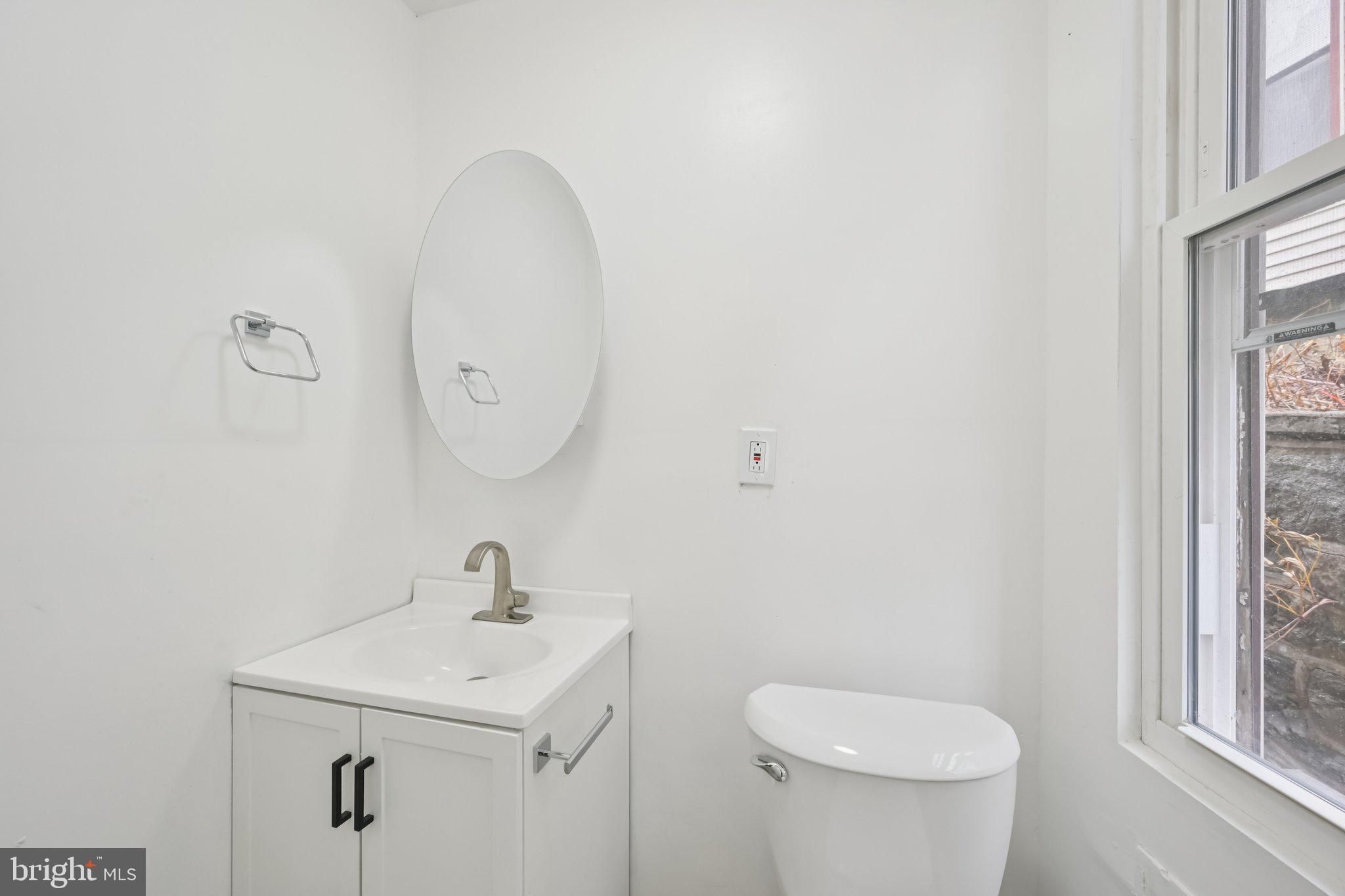 704 Main Street Darby, PA 19023 - Photo 11 of 28 a bathroom with a sink and a mirror