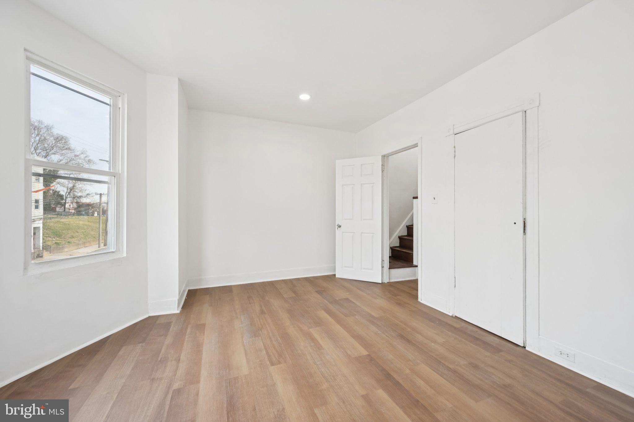 704 Main Street Darby, PA 19023 - Photo 14 of 28 a view of an empty room with wooden floor and a window