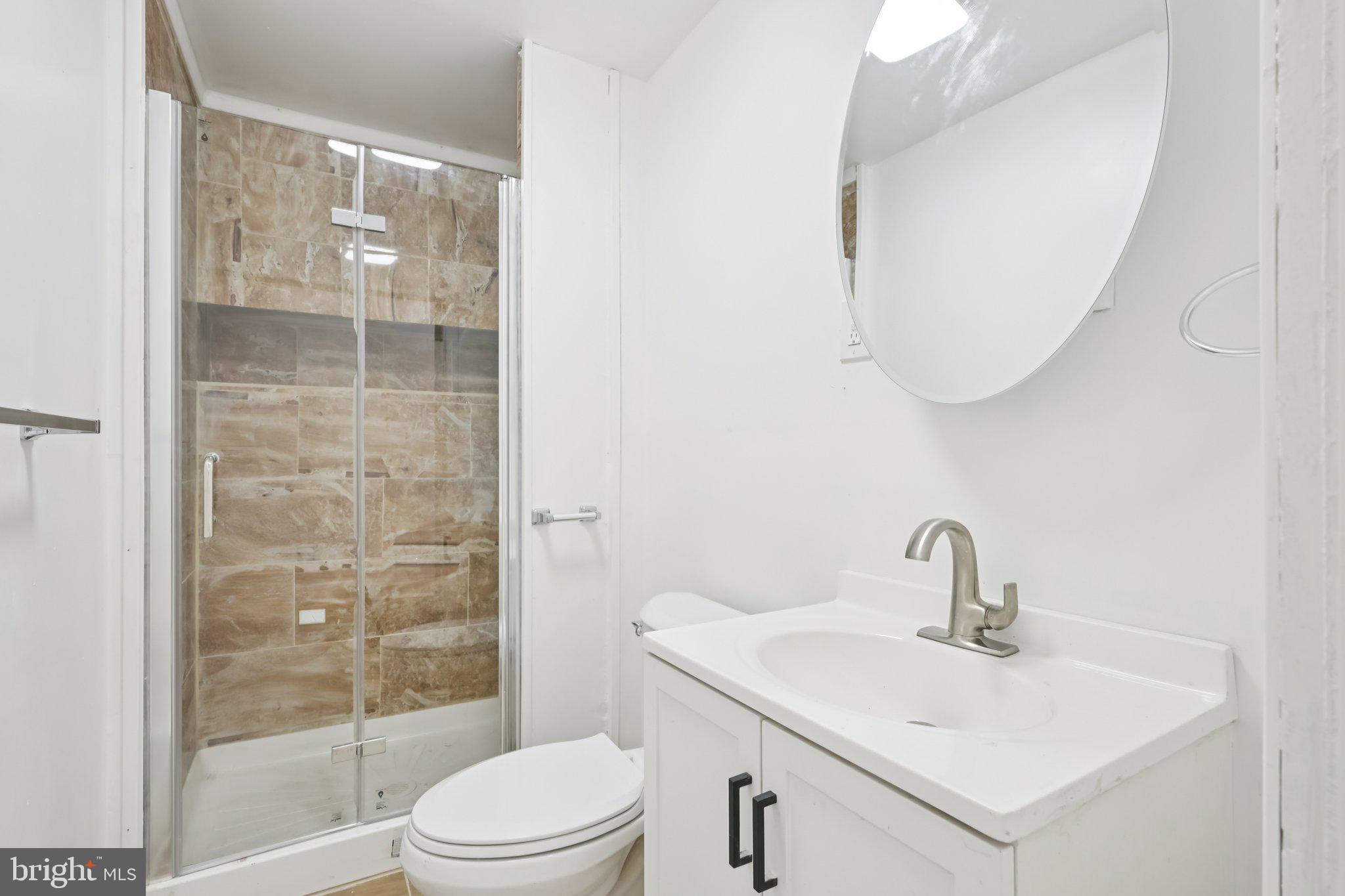 704 Main Street Darby, PA 19023 - Photo 19 of 28 a bathroom with a sink toilet and shower