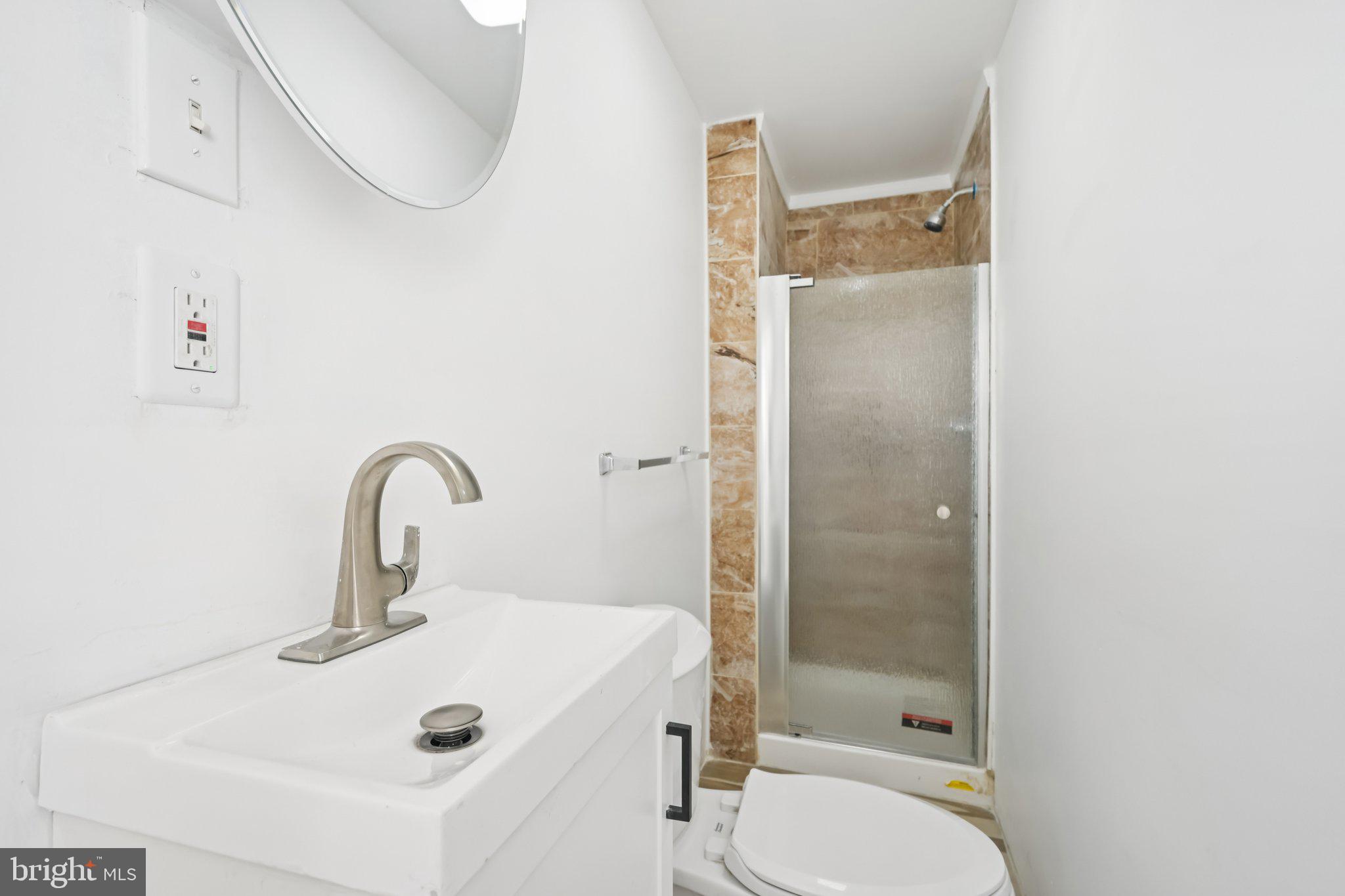704 Main Street Darby, PA 19023 - Photo 25 of 28 a bathroom with a sink a toilet and shower