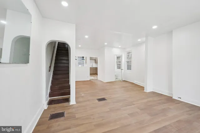 a view of an empty room with wooden floor