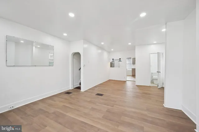 a view of empty room with wooden floor