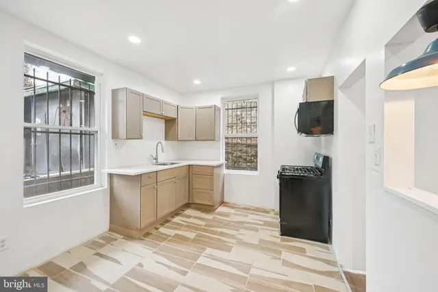a kitchen with a refrigerator sink and wooden cabinets
