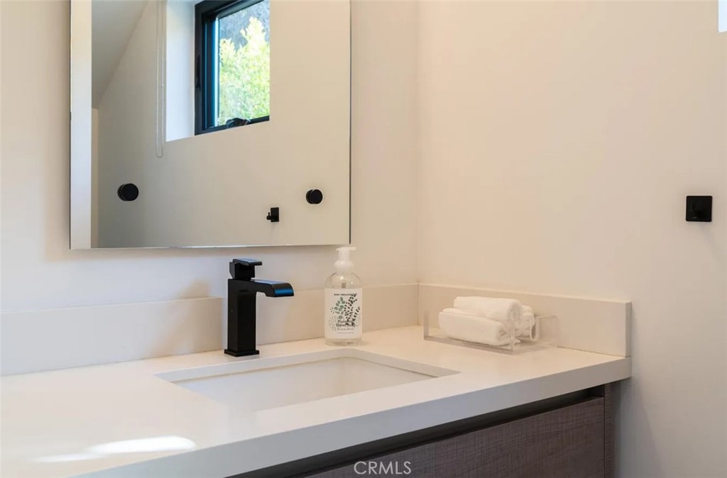 12134 Clarkson Road Los Angeles, CA 90064 - Photo 15 of 25 a bathroom with a sink and a mirror