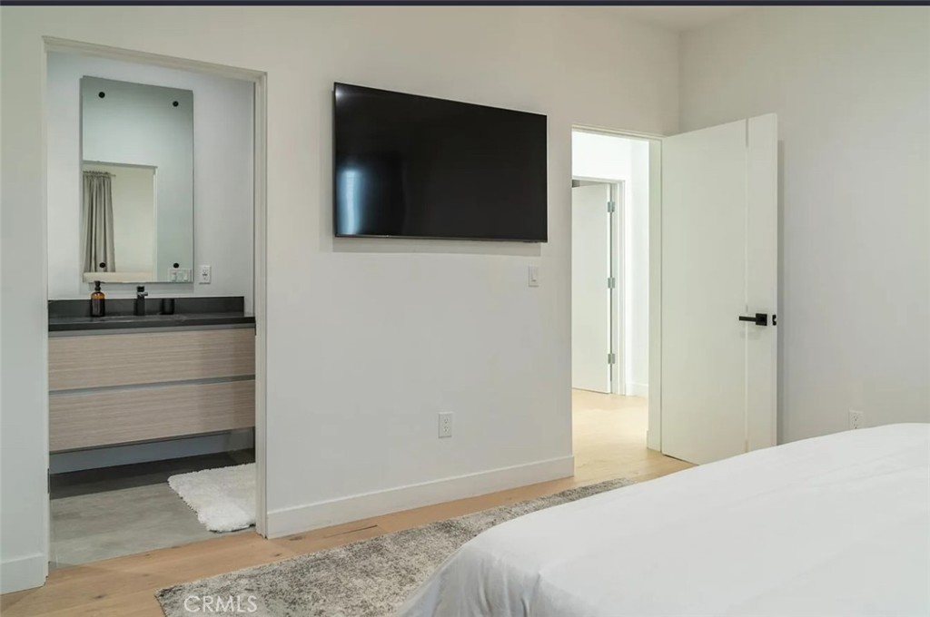 12134 Clarkson Road Los Angeles, CA 90064 - Photo 18 of 25 a bedroom with a bed and a television
