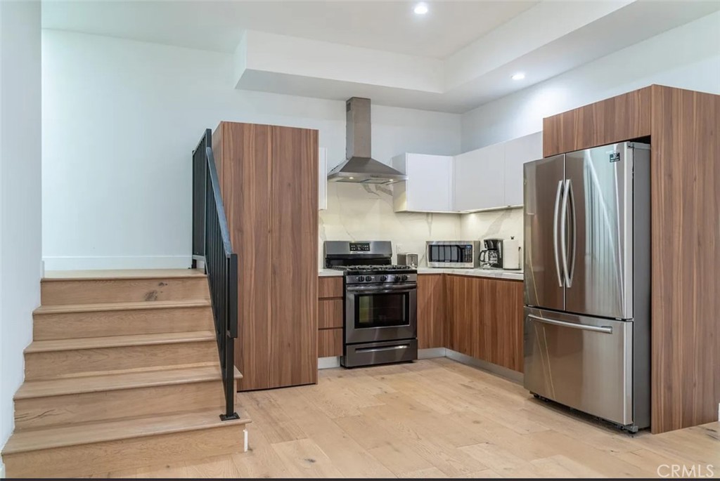 12134 Clarkson Road Los Angeles, CA 90064 - Photo 3 of 25 a kitchen with stainless steel appliances granite countertop a refrigerator and a stove top oven
