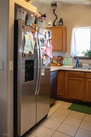 a view of a kitchen with fridge and window