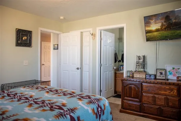 a bedroom with a bed and a flat screen tv