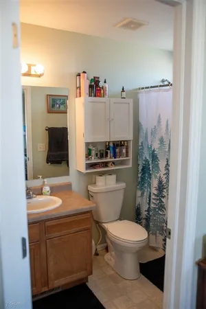 a bathroom with a toilet a sink and a mirror