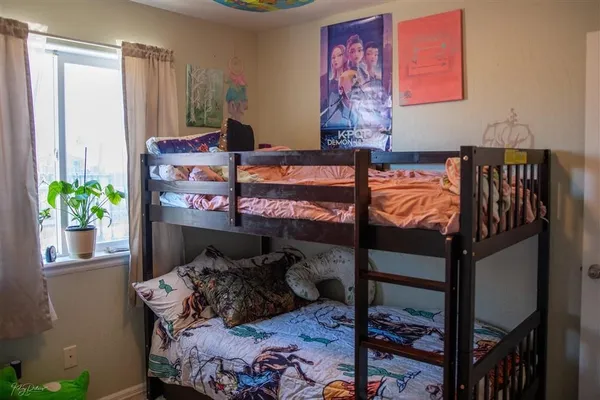 a bed room with furniture and a potted plant