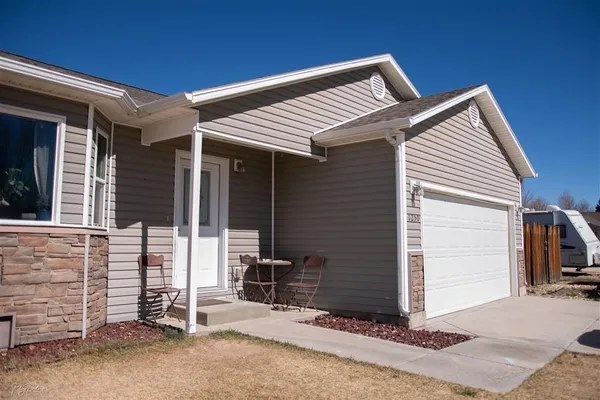 a view of a house with backyard and a chair