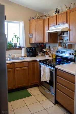 a kitchen with stainless steel appliances granite countertop a sink stove and microwave