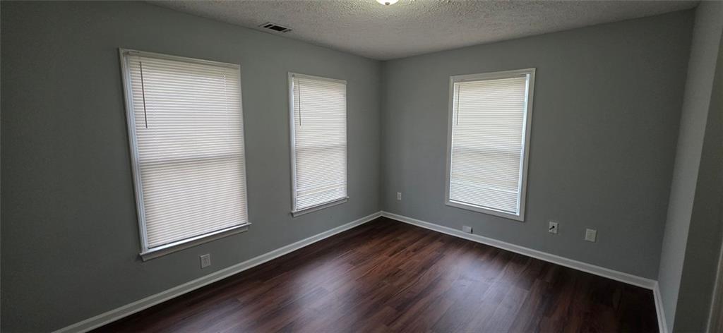 688 Smith Street Southwest Atlanta, GA 30310 - Photo 11 of 15 an empty room with wooden floor and windows