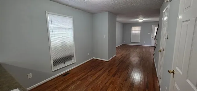 a view of hallway with wooden floor
