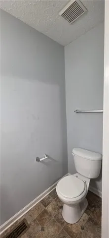 a white toilet sitting next to a shower
