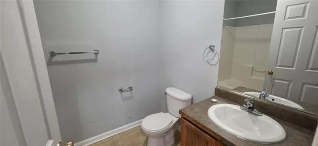 a bathroom with a sink toilet and a mirror
