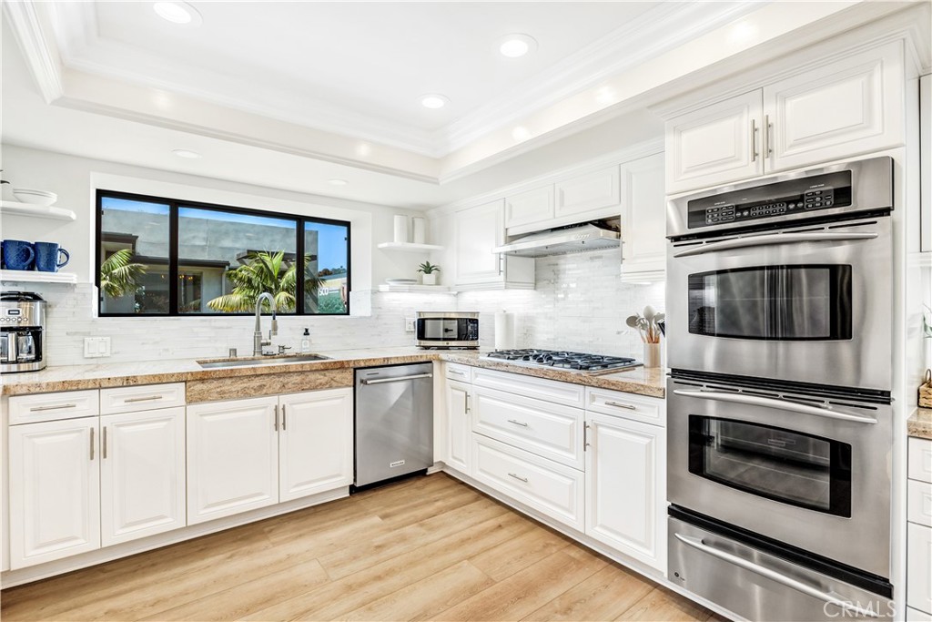 32041 Point Place Laguna Beach, CA 92651 - Photo 17 of 49 a kitchen with white cabinets stainless steel appliances and sink