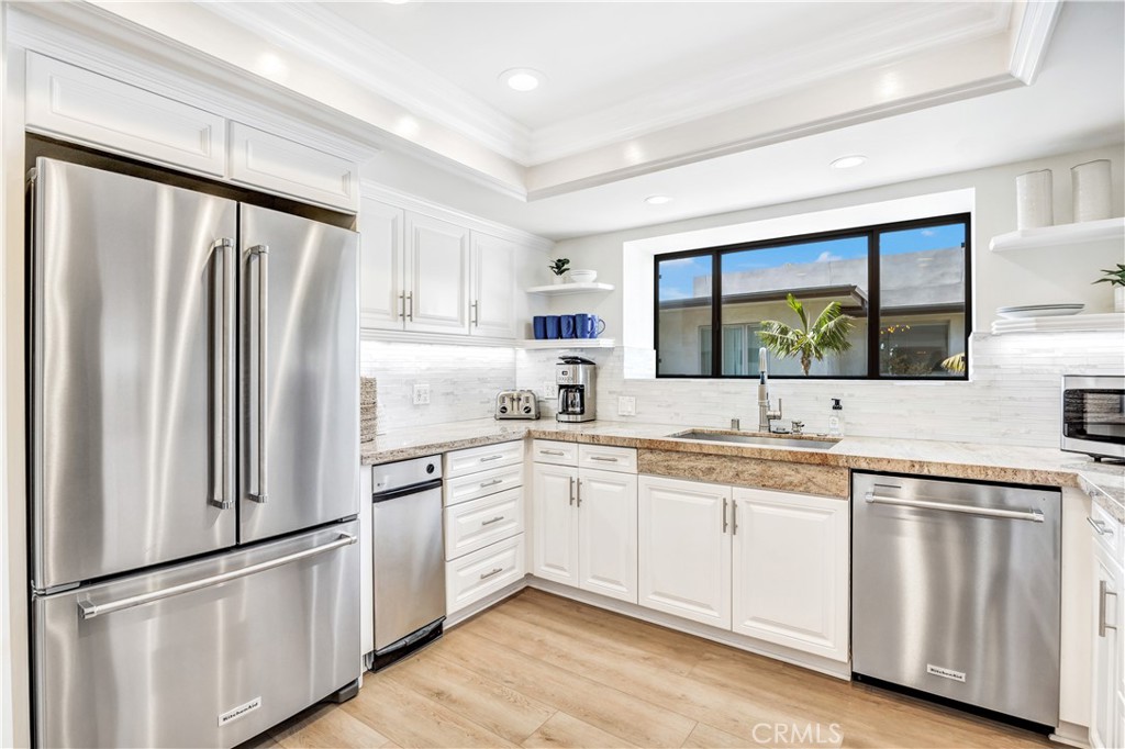 32041 Point Place Laguna Beach, CA 92651 - Photo 18 of 49 a kitchen with white cabinets and white appliances
