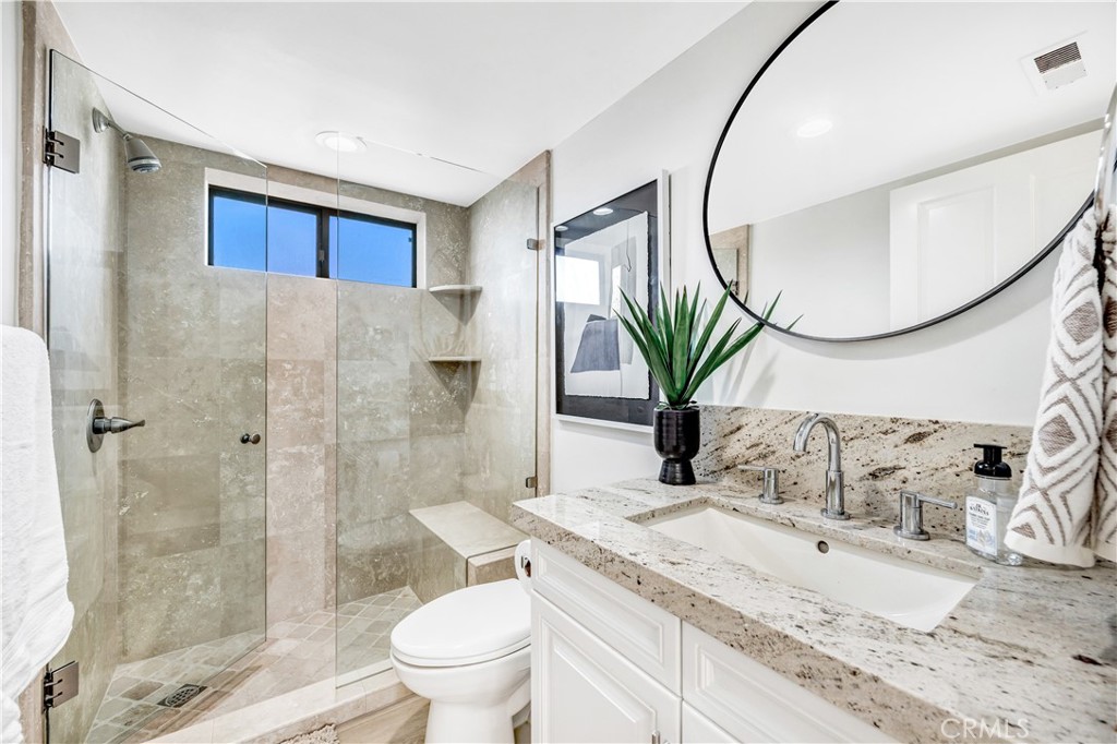 32041 Point Place Laguna Beach, CA 92651 - Photo 21 of 49 a bathroom with a granite countertop sink a toilet and shower