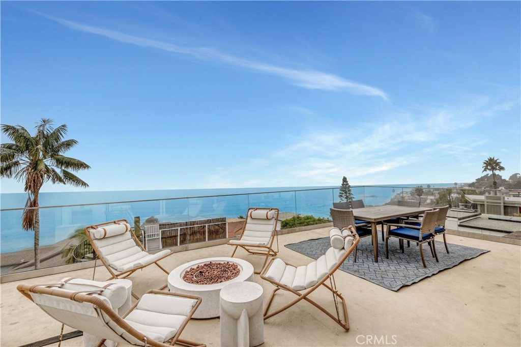 32041 Point Place Laguna Beach, CA 92651 - Photo 3 of 49 a view of a patio with table and chairs and potted plants with wooden floor