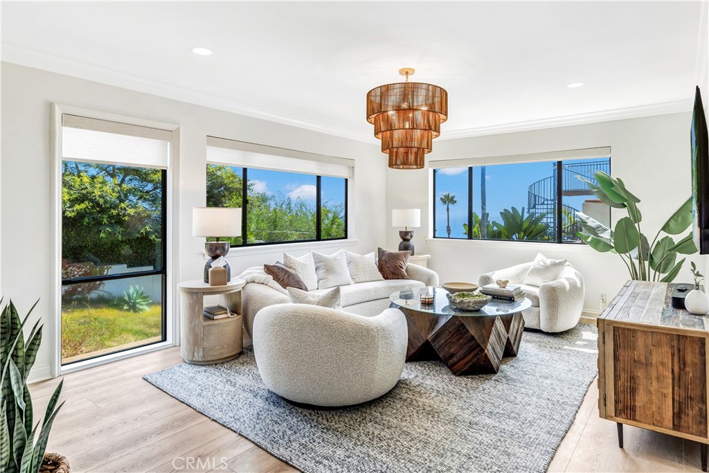 32041 Point Place Laguna Beach, CA 92651 - Photo 8 of 49 a living room with furniture a chandelier and a large window