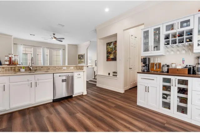 a kitchen with stainless steel appliances cabinets a sink and a window