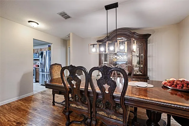 a dining room with furniture and chandelier