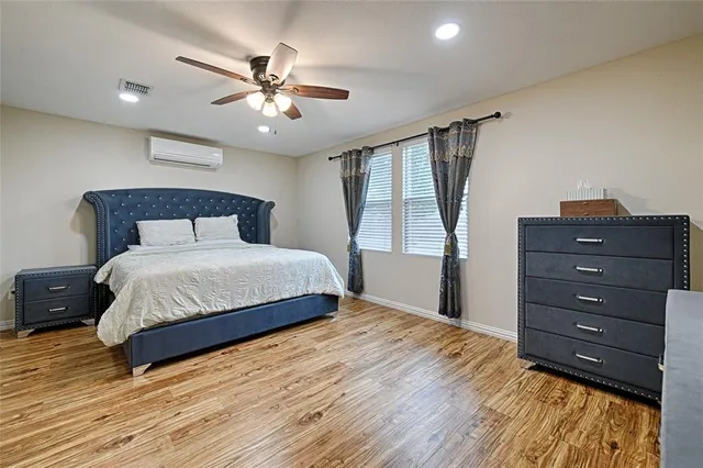 a bedroom with a bed window and a ceiling fan