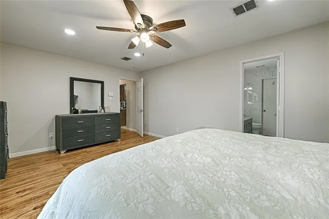 a bedroom with a bed and a dresser