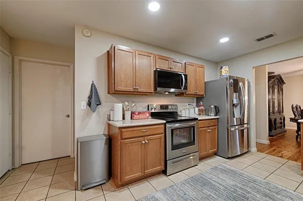 a kitchen with stainless steel appliances a stove a sink refrigerator and microwave
