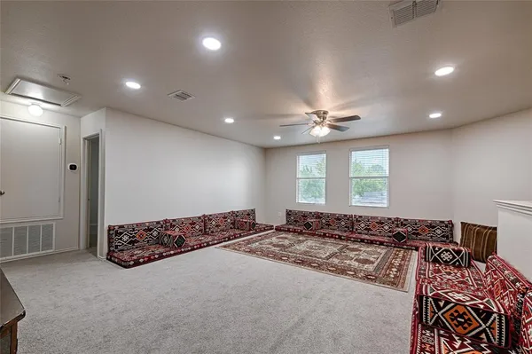a large bedroom with a bed and a chandelier