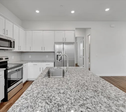 a kitchen with stainless steel appliances granite countertop a refrigerator sink and cabinets