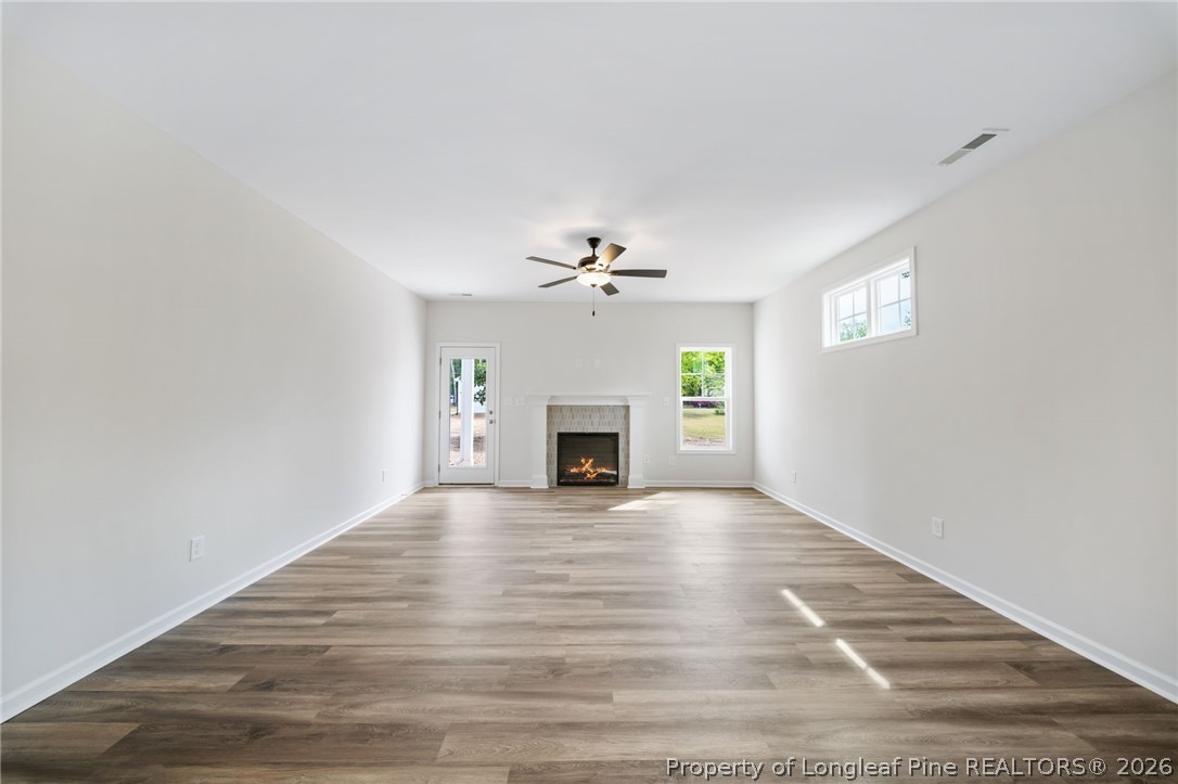 4052 Lofton Street Wade, NC 28395 - Photo 3 of 22 a view of an empty room with a fireplace and a window