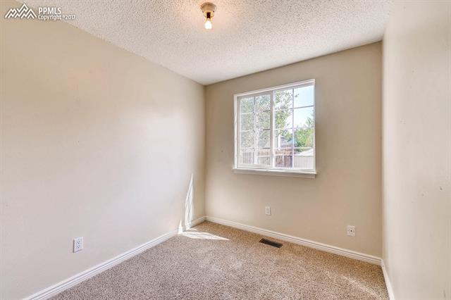 1875 Doherty Road Colorado Springs, CO 80916 - Photo 8 of 11 Second bedroom very bright with lots of natural light.