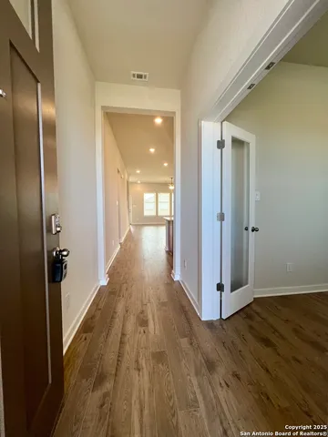 a view of an empty room and wooden floor