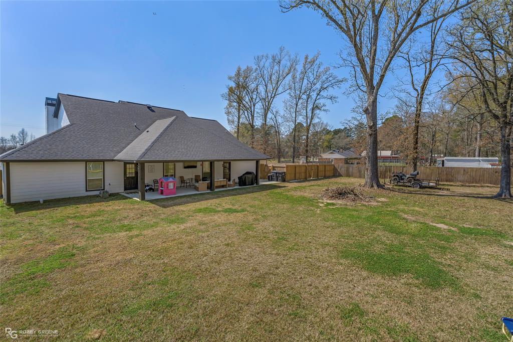 396 Collinswood Road Stonewall, LA 71078 - Photo 7 of 32 a house with huge green field in front of it