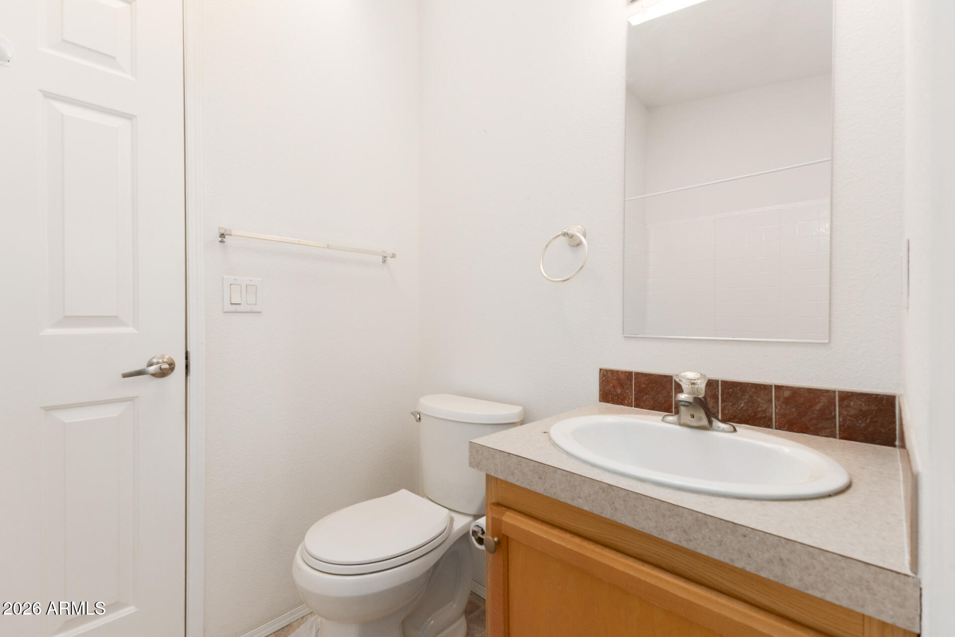 16101 North El Mirage Road, Unit 429 El Mirage, AZ 85335 - Photo 16 of 31 a bathroom with a granite countertop sink toilet and a mirror