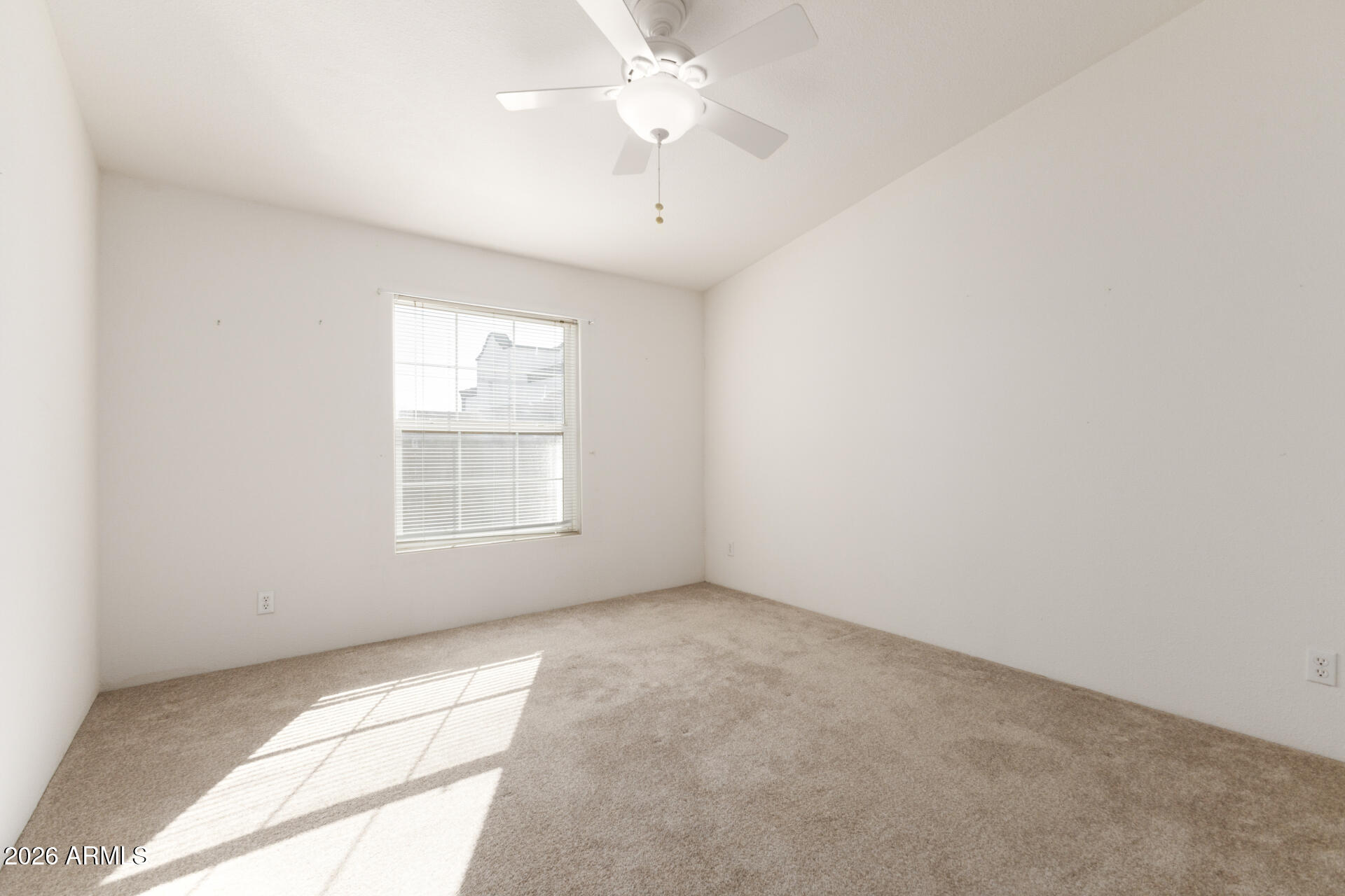 16101 North El Mirage Road, Unit 429 El Mirage, AZ 85335 - Photo 18 of 31 an empty room with chandelier fan and windows