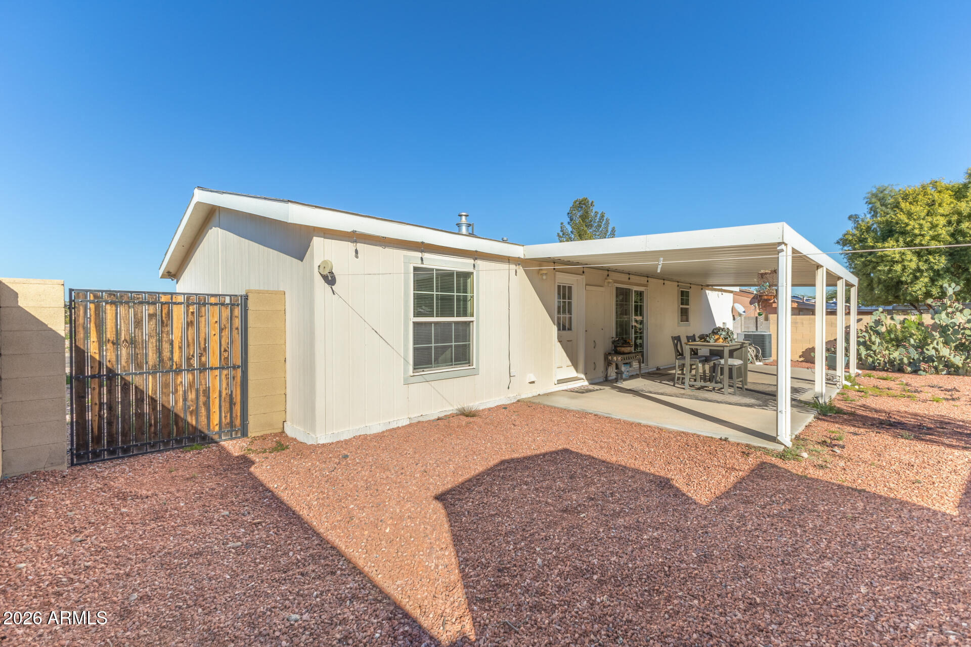 16101 North El Mirage Road, Unit 429 El Mirage, AZ 85335 - Photo 22 of 31 a view of a house with backyard porch and wooden fence
