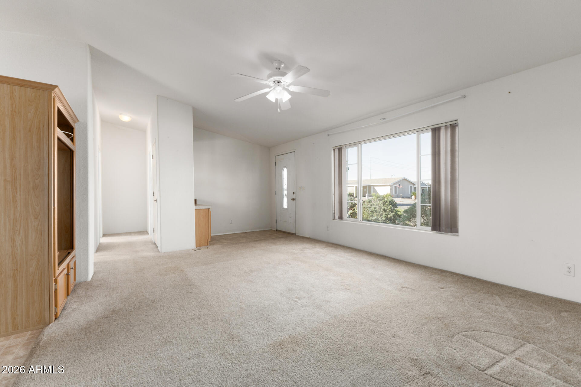 16101 North El Mirage Road, Unit 429 El Mirage, AZ 85335 - Photo 4 of 31 an empty room with windows and refrigerator