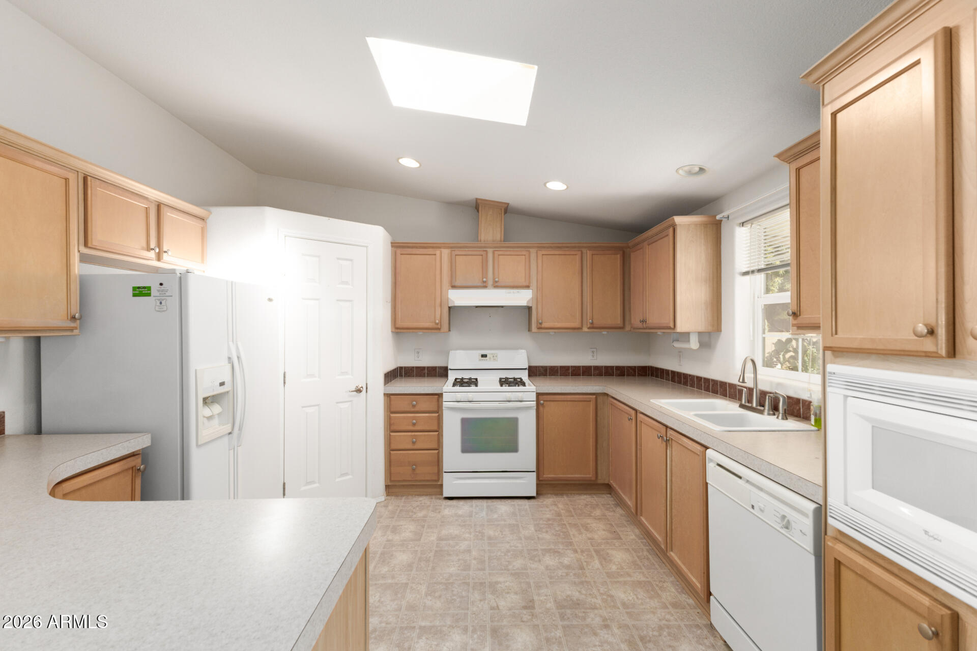 16101 North El Mirage Road, Unit 429 El Mirage, AZ 85335 - Photo 5 of 31 a kitchen with a sink stove and refrigerator