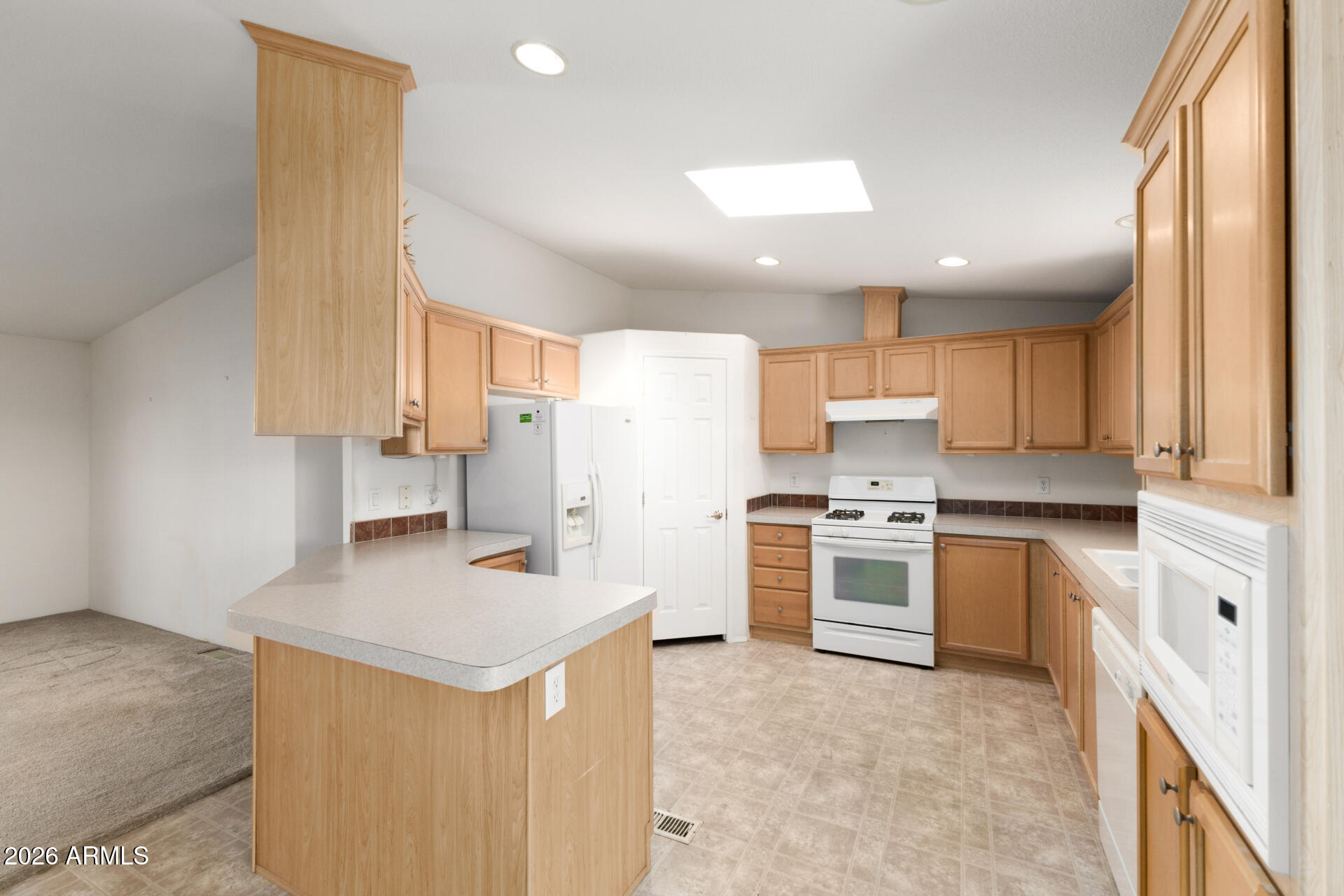 16101 North El Mirage Road, Unit 429 El Mirage, AZ 85335 - Photo 6 of 31 a kitchen with a stove a sink and a refrigerator